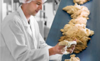 man working with tortillas on a conveyor belt