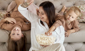 woman and children eating popcorn
